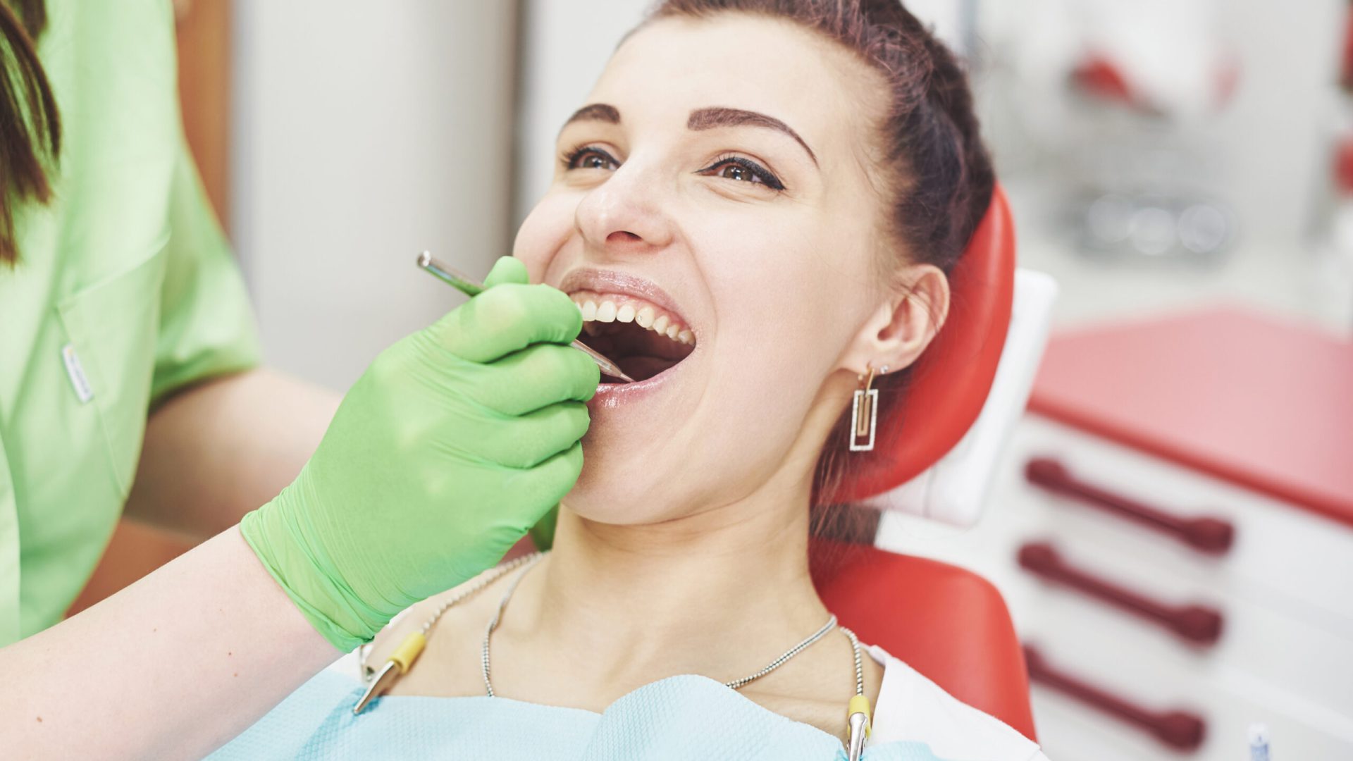 Dentist curing a female patient in the stomatology. Early prevention and oral hygiene concept.